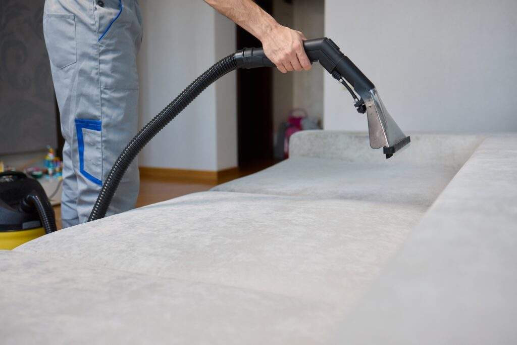 person vacumming a couch